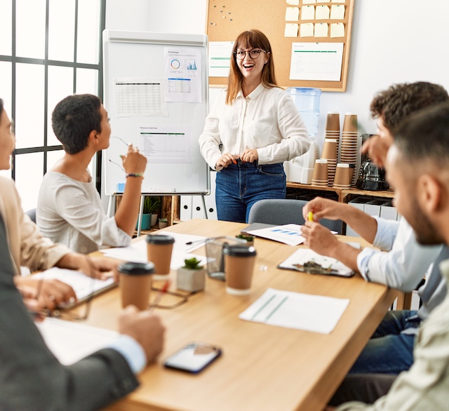 Young woman leads a meeting of diverse colleagues