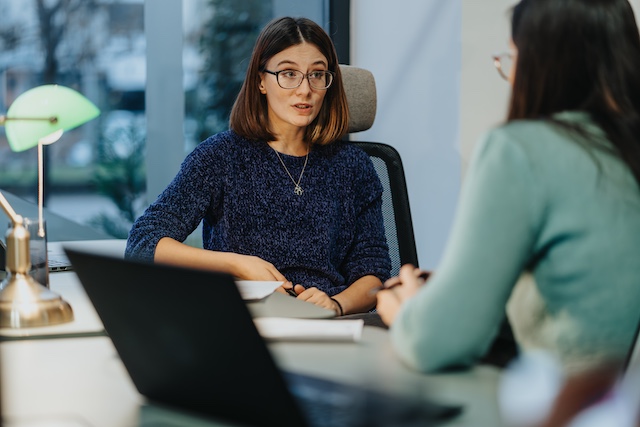 A female manager meets with her female employee to have a difficult conversation at work