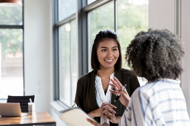 A female manager offers feedback to a female employee